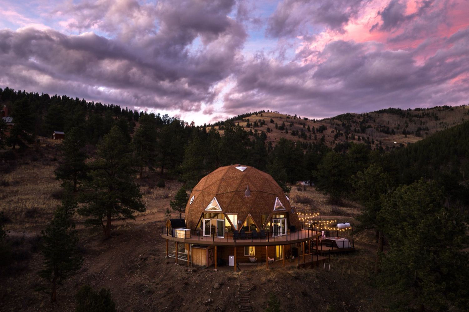 The Luna Dome glowing at dusk on its forested hillside near Idaho Springs, Colorado